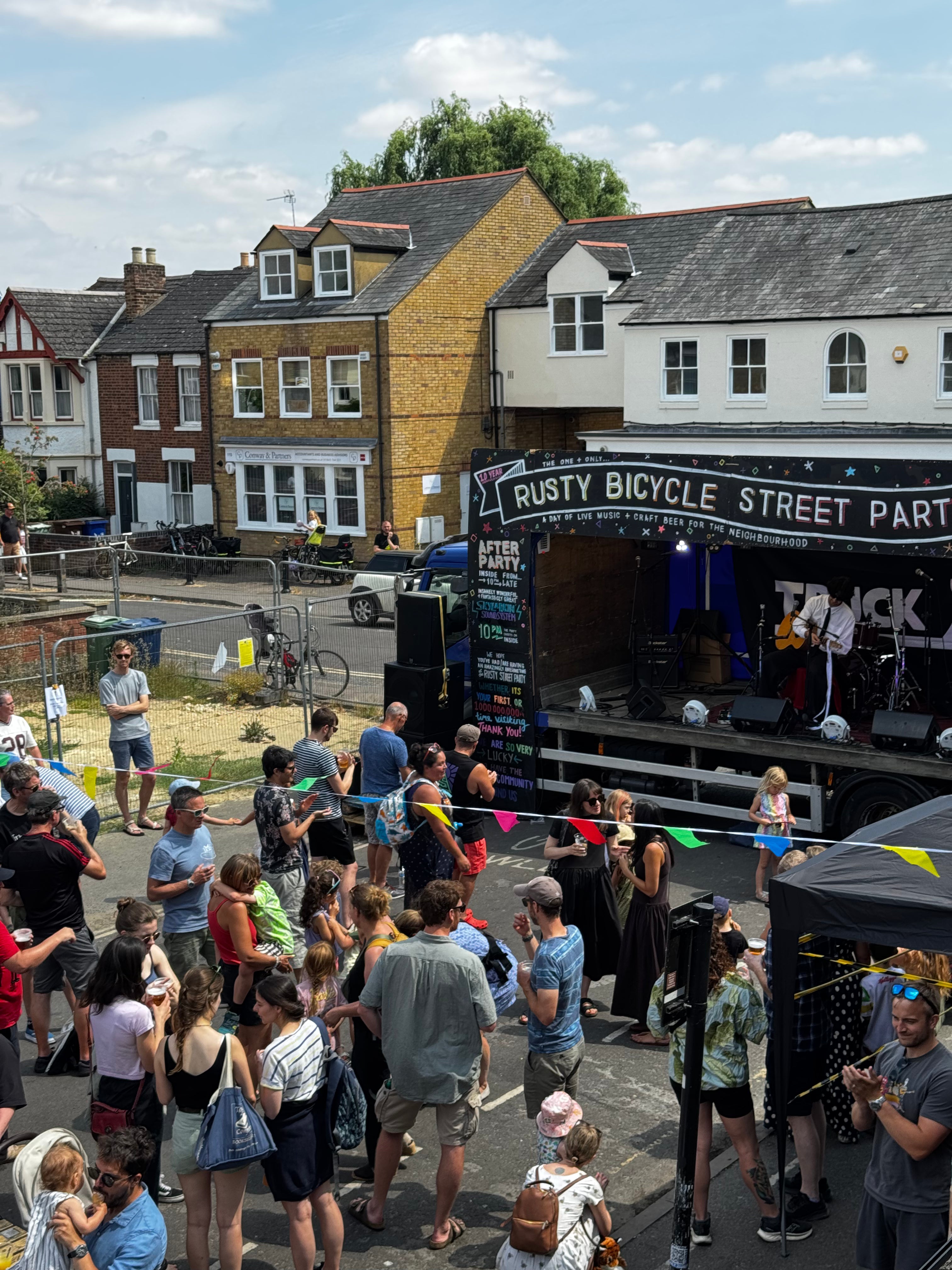 Crowd enjoying live music at The Rusty Bicycle street party