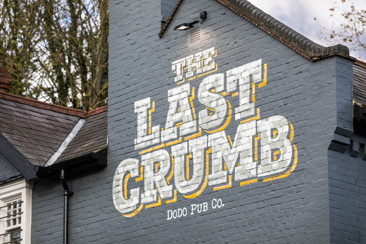 The Last Crumb sign painted on the side of the pub building