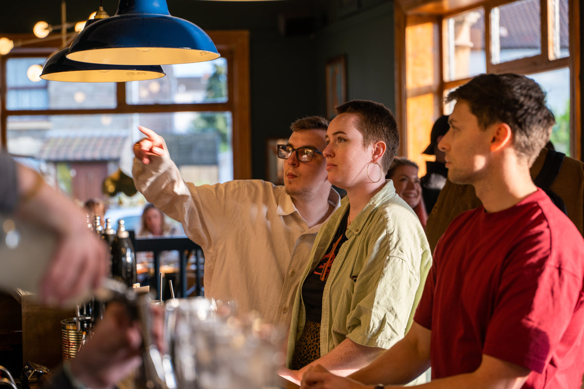 Customers ordering drinks at a busy bar