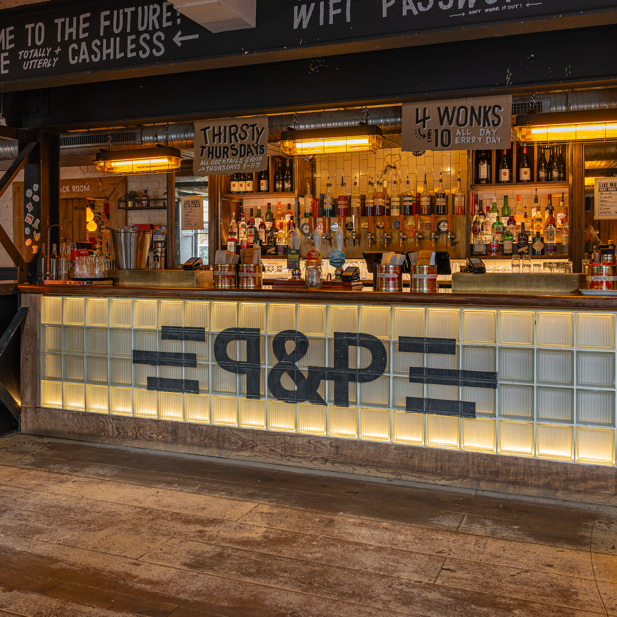 Bar at The Part & Parcel with a lit P&P bar front