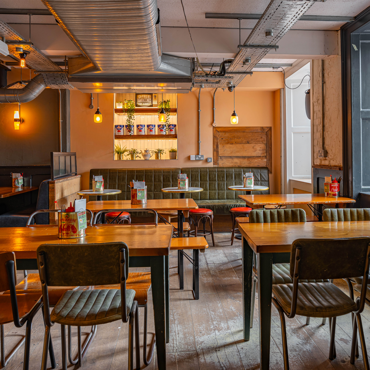 Dining area at The Part & Parcel with wooden tables and industrial ceiling