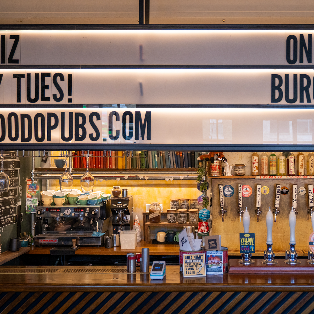 Bar at The Up In Arms with beer taps and a coffee machine
