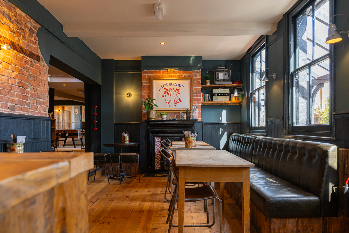 Interior of The High Horse with leather booth seating and wooden tables