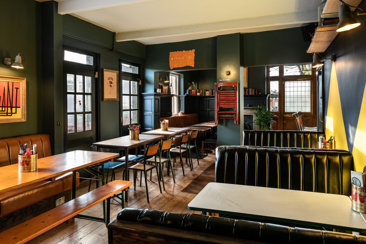 Dining area at The Last Crumb with leather booths and wooden tables
