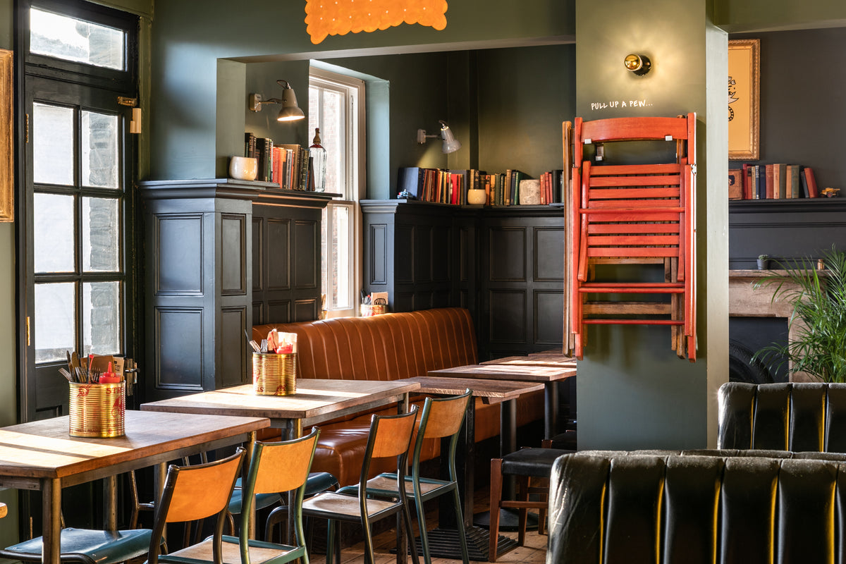 Dining area at The Last Crumb with leather booths and wooden tables
