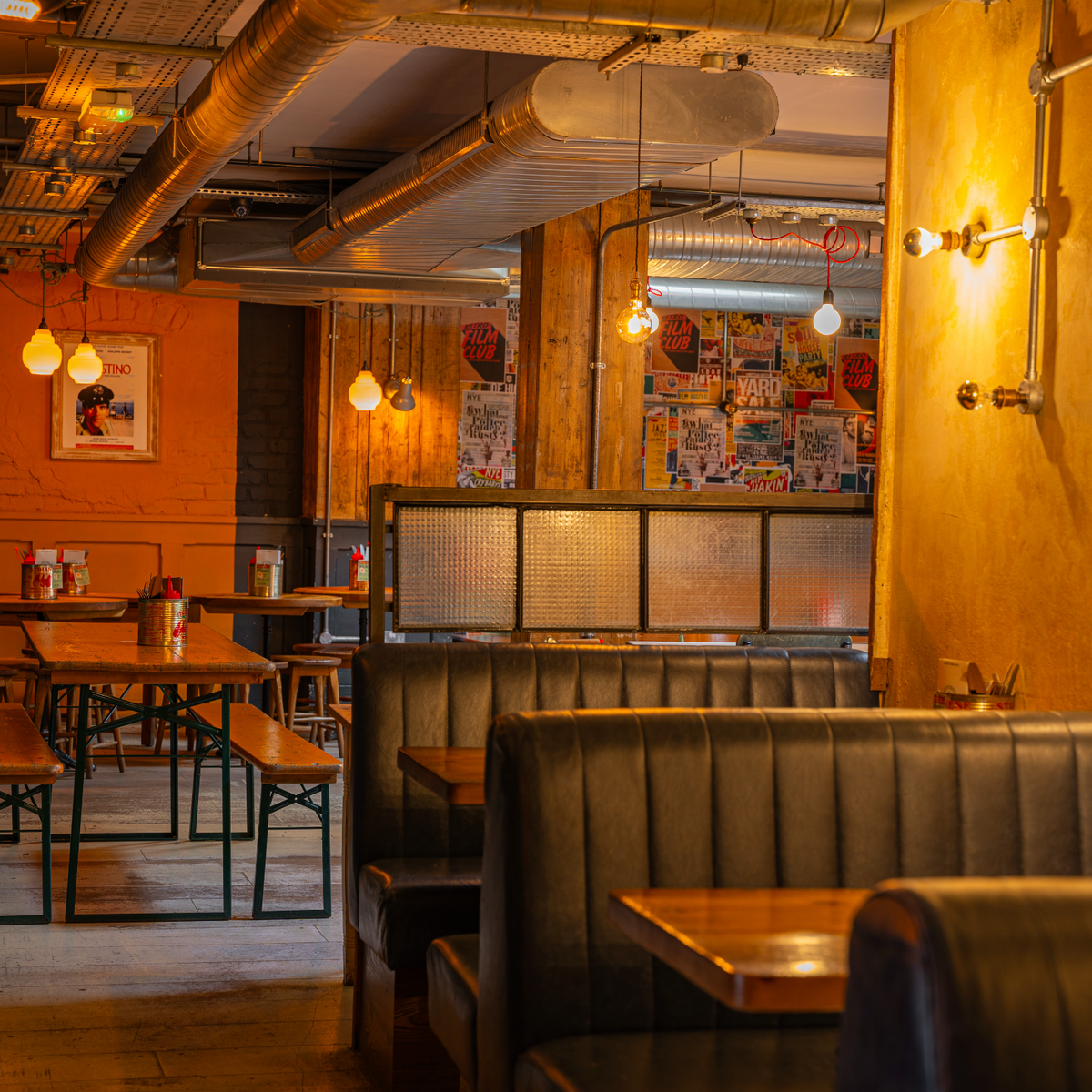 Interior of The Part & Parcel with leather booths and warm lighting
