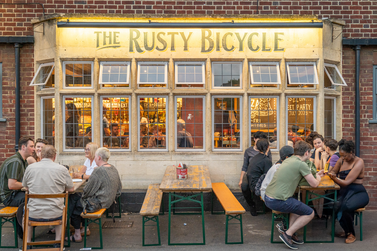 Customers at picnic benches outside the front of The Rusty Bicycle