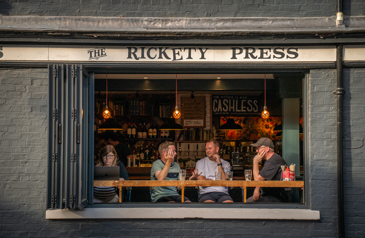 Customers sitting in the front window of The Rickety Press